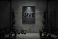 GiVE motivational framed poster on concrete wall in home gym